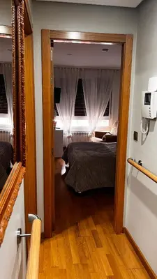 a view of a bedroom with a bed and a mirror at Acogedor piso céntrico in Lugo