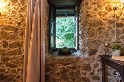 a room with a window in a stone wall at Casa con Piscina *Ribeira Sacra* in Ferreira de Panton