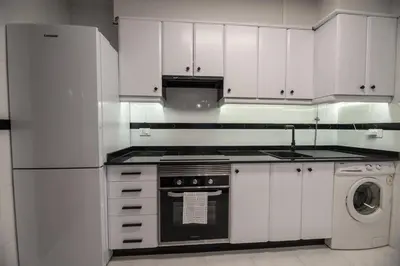 a white kitchen with a stove and a dishwasher at Apartamento acogedor centrico in Monforte de Lemos