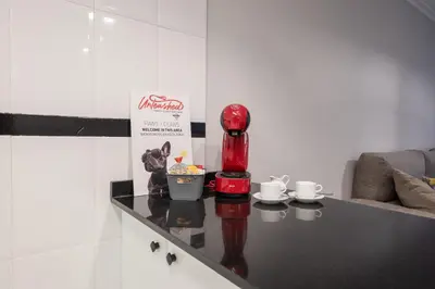 a table in a room with a red blender and cups at Apartamento acogedor centrico in Monforte de Lemos