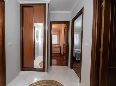 a hallway with two mirrors and a room with a bedroom at Apartamento acogedor centrico in Monforte de Lemos