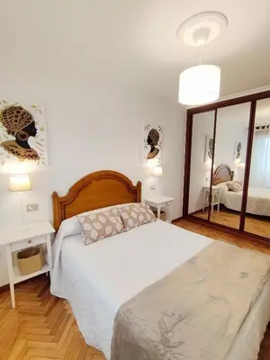 a bedroom with a bed and a large mirror at Neboa in Viveiro