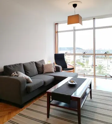 a living room with a couch and a table at Neboa in Viveiro