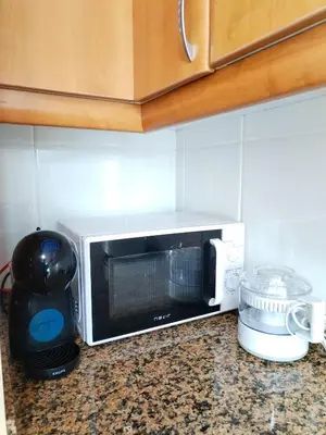 a microwave sitting on a counter in a kitchen at Neboa in Viveiro