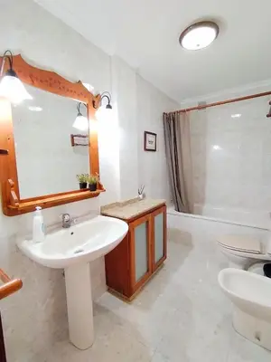 a bathroom with a sink and a mirror and a tub at Neboa in Viveiro