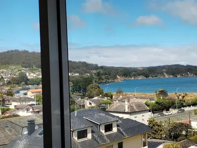 a view of the ocean from a window at Neboa in Viveiro