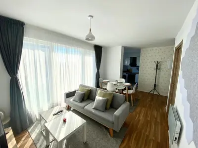 a living room with a couch and a table at Apartamentos LAMAROSA -LAS PLAYAS in Burela de Cabo