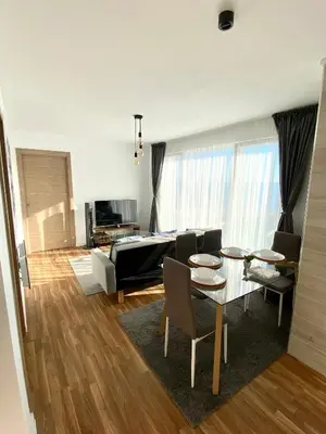 a living room with a table and a couch at Apartamentos LAMAROSA -LAS PLAYAS in Burela de Cabo