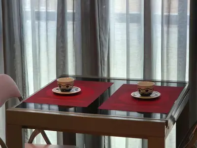 two cups of coffee sitting on a glass table at Alojamiento en Ares a 2 minutos de la playa in Ares
