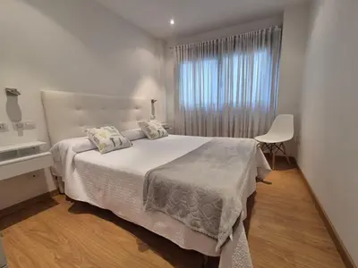 a bedroom with a white bed and a window at Alojamiento en Ares a 2 minutos de la playa in Ares