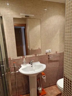 a bathroom with a sink and a mirror and a toilet at Alojamiento en Ares a 2 minutos de la playa in Ares