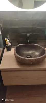 a bathroom sink sitting on top of a wooden counter at Doctor Gasalla in Lugo