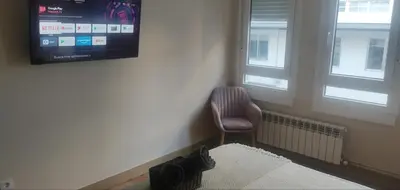 a room with a chair and a television on the wall at Doctor Gasalla in Lugo