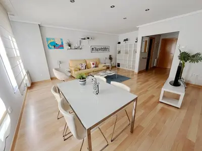 a living room with a white table and chairs at Dúplex Valle del Silencio in Ponferrada