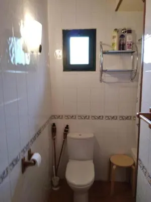a small bathroom with a toilet and a window at La Casa de Trefacio in Trefacio