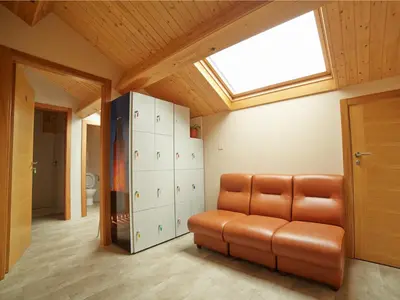a living room with a couch and a skylight at Albergue Pereiro in Melide