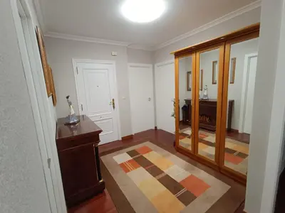 a hallway with a room with a mirror and a table at Apartamento Plaza in Caldas de Reis
