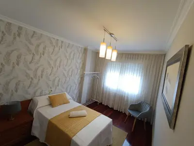a hotel room with a bed and a window at Apartamento Plaza in Caldas de Reis
