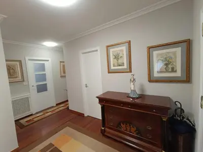an empty living room with a dresser and a door at Apartamento Plaza in Caldas de Reis