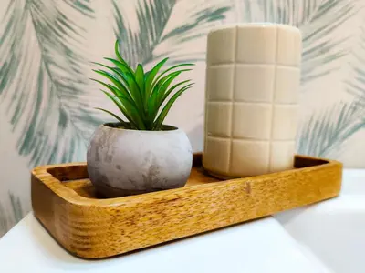 a wooden tray with a plant and a candle at Apartamento Pena Furada in Ribadeo