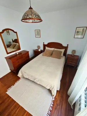 a bedroom with a bed and a large mirror at Apartamento Pena Furada in Ribadeo