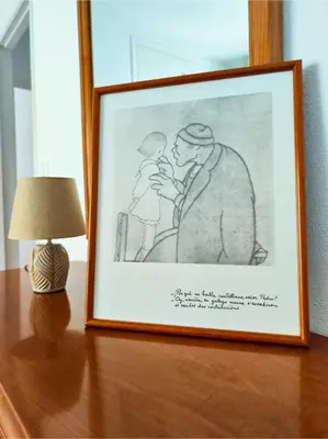 a framed drawing of a man kissing a woman at Apartamento Pena Furada in Ribadeo