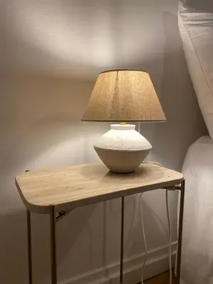 a lamp on a wooden table next to a bed at Terraza as Travesas in Betanzos