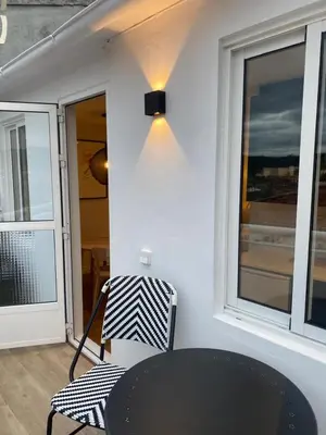 a table and a chair in a room with a window at Terraza as Travesas in Betanzos