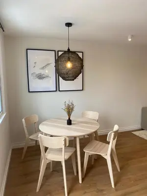 a dining room with a white table and chairs at Terraza as Travesas in Betanzos