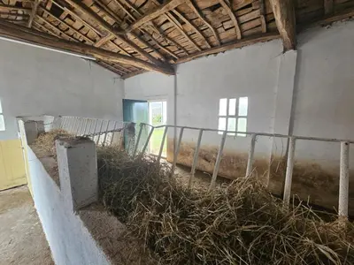 a room with a pile of hay in a building at CASA DAVID-con cuadras para caballos in Arzúa