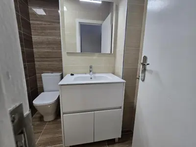 a bathroom with a white sink and a toilet at CASA DAVID-con cuadras para caballos in Arzúa