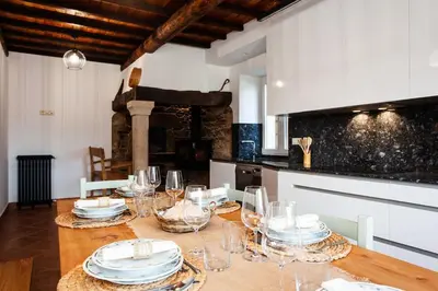 a table with glasses and plates on it in a kitchen at Casa do Cesteiro in Santiago de Compostela