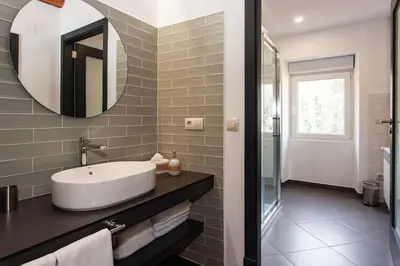 a bathroom with a sink and a mirror at Casa do Cesteiro in Santiago de Compostela