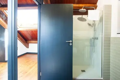 a blue door in a bathroom with a shower at Casa do Cesteiro in Santiago de Compostela