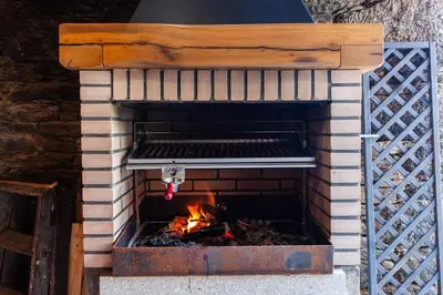 a brick oven with a fire inside of it at Casa do Cesteiro in Santiago de Compostela