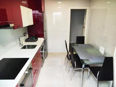 a kitchen with a sink and a table with chairs at Alojamiento en Santiago de Compostela-Galicia in Santiago de Compostela