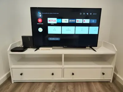 a tv sitting on a white entertainment center at Alojamiento en Santiago de Compostela-Galicia in Santiago de Compostela