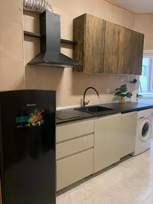 a kitchen with a black refrigerator and a sink at Segundo Antolín Yellow Door in Ponferrada