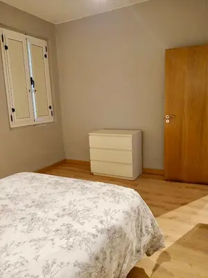 a bedroom with a bed and a wooden cabinet at Segundo Antolín Yellow Door in Ponferrada