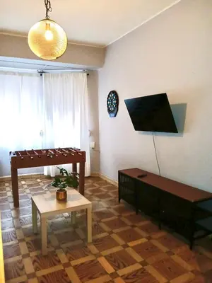 a living room with a couch and a piano at Segundo Antolín Yellow Door in Ponferrada