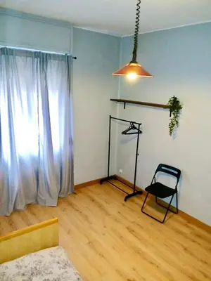 a living room with a window and a chair at Segundo Antolín Yellow Door in Ponferrada