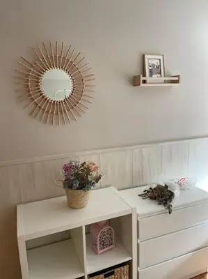 a mirror on a wall above a white dresser at Villaduranchi in Villablino