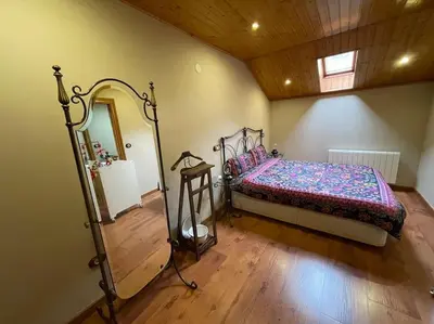 a bedroom with a bed and a mirror at Villaduranchi in Villablino