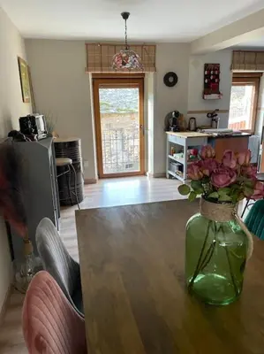 a living room with a vase of flowers on a table at Villaduranchi in Villablino