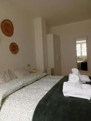 a bedroom with a bed with towels on it at O Soño de Santiago - Casa rural Mondoñedo, Galicia in Mondoñedo