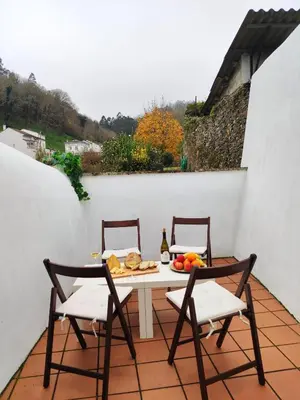 a table and chairs on a patio with food on it at O Soño de Santiago - Casa rural Mondoñedo, Galicia in Mondoñedo