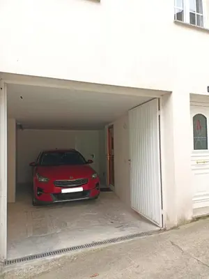 a red car is parked inside of a garage at O Soño de Santiago - Casa rural Mondoñedo, Galicia in Mondoñedo
