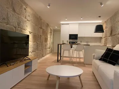 a living room with a couch and a table at LAS TERRAZAS II Apartamento de lujo frente a la Catedral in Ourense
