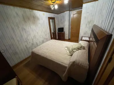 a small bedroom with a bed and a television at CASA GUIMARAS in Cortes