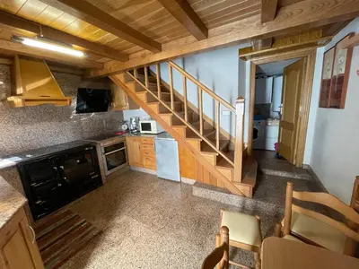 a small kitchen with a staircase in a house at CASA GUIMARAS in Cortes
